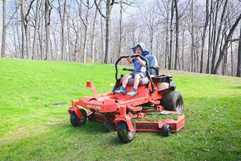 He drives the zero turn lawn mower! 2 years old helping dad mow the lawn